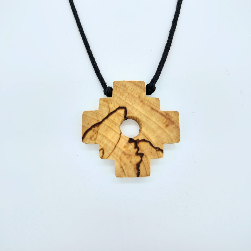 a chakana shaped pendant made of natural palo santo wood that is very fragrant and considered very high frequency in spirituality for cleansing and clearing and attracting good energy