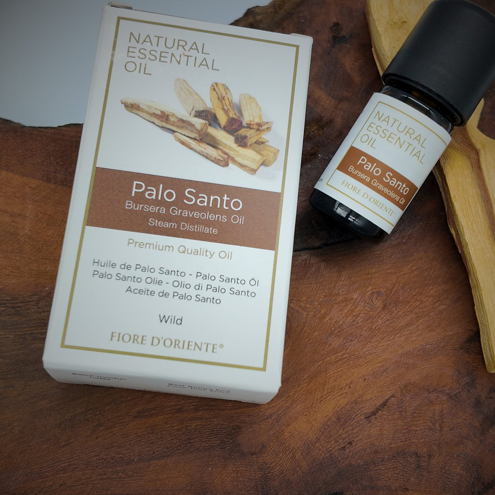 a bottle containing pure palo santo blended essential oil and its packaging box