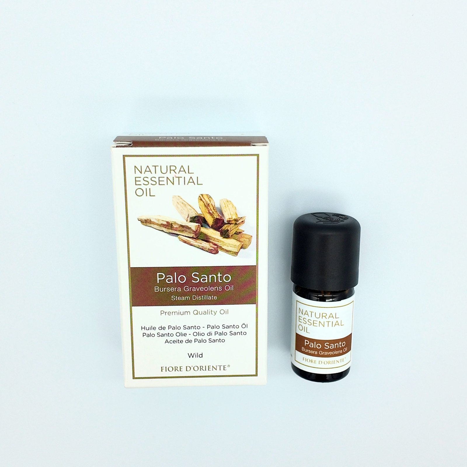 a bottle containing pure palo santo blended essential oil and its packaging box