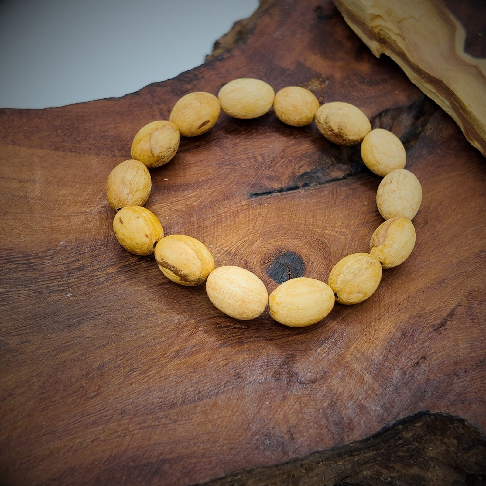 a beaded bracelet made of natural palo santo wood that is very fragrant and considered very high frequency in spirituality for cleansing and clearing and attracting good energy