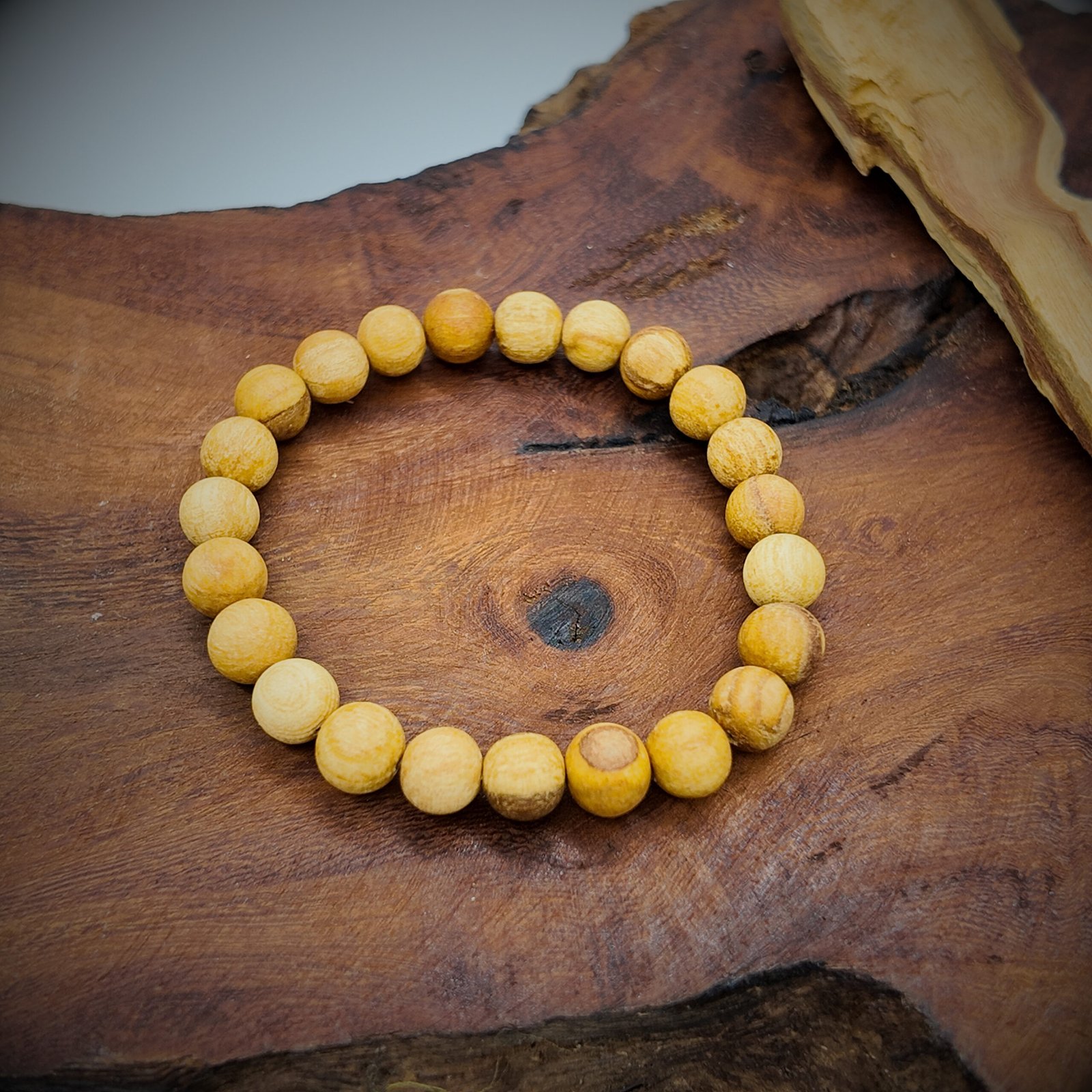 a beaded bracelet made of natural palo santo wood that is very fragrant and considered very high frequency in spirituality for cleansing and clearing and attracting good energy