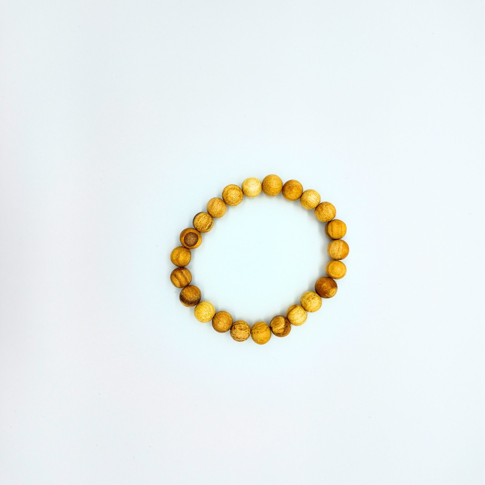 a beaded bracelet made of natural palo santo wood that is very fragrant and considered very high frequency in spirituality for cleansing and clearing and attracting good energy