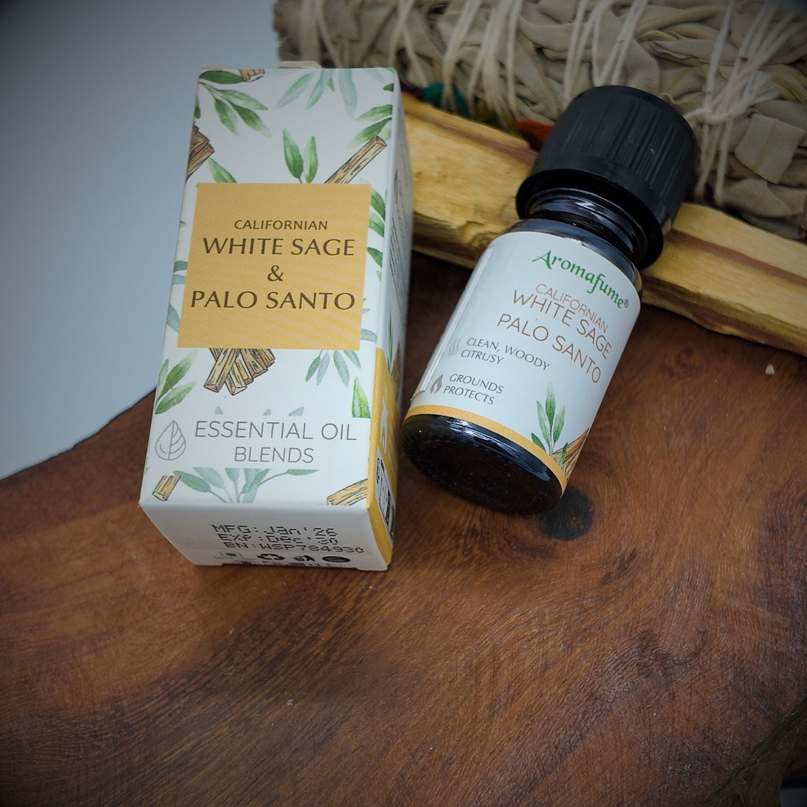 a bottle containing white sage and palo santo blended essential oil and its packaging box
