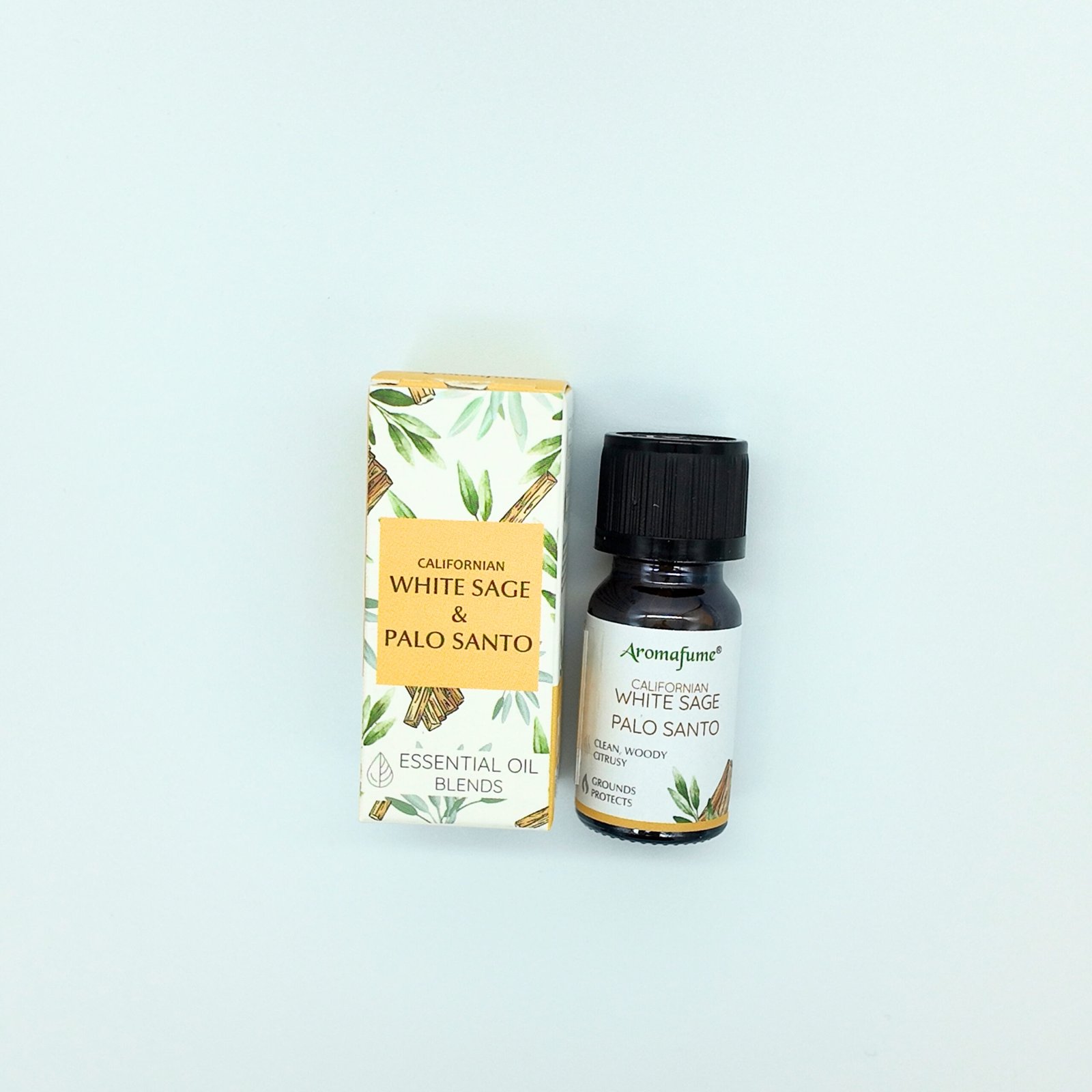 a bottle containing white sage and palo santo blended essential oil and its packaging box